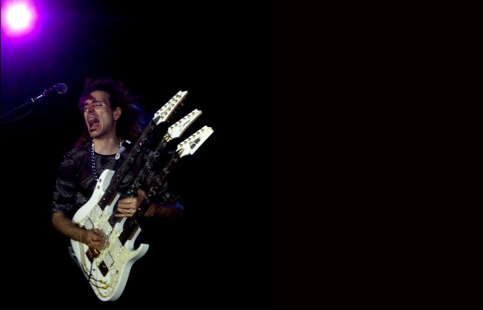 Steve Vai with triple neck guitar