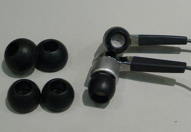Coppia di in-ear monitor con gommini in silicone e cavo modellato sopra l'orecchio